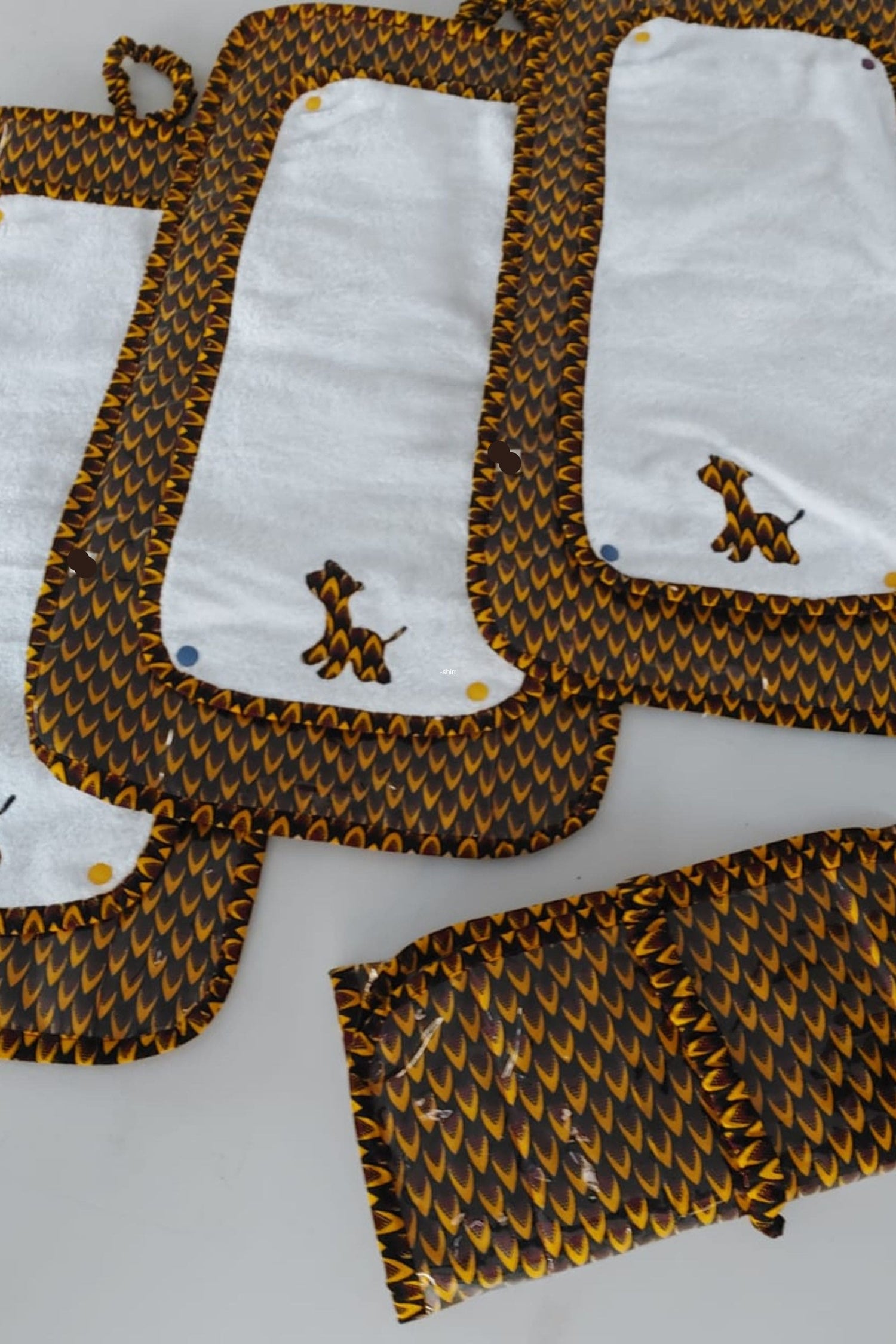 A collection of childcare items such as Diaper change mat and blankets by Atelier Djeeg'n